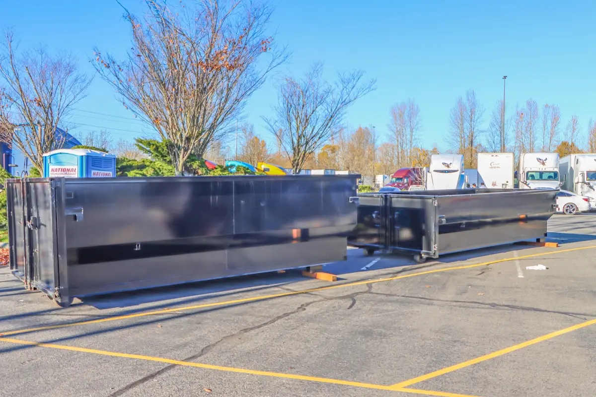 Professional dumpster rental service with roll-off container on residential driveway in Ivins